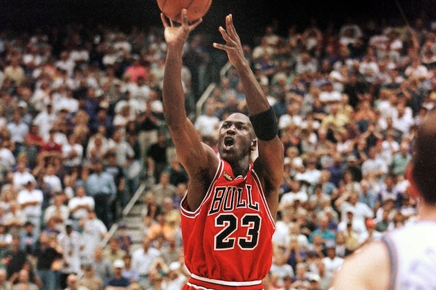 With 5.2 seconds left in the game Michael Jordan of the Chicago Bulls (C) aims and shoots the game-winning jump shot as Bryon Russell of the Utah Jazz (L) drives at Jordan's feet 14 June during game six of the NBA Finals with the Utah Jazz at the Delta Center in Salt Lake City, UT. The Bulls won the game 87-86 to win their sixth NBA championship. AFP PHOTO/Jeff HAYNES (Photo by JEFF HAYNES / AFP) (Photo by JEFF HAYNES/AFP via Getty Images) With 5.2 seconds left in the game Michael Jordan of the Chicago Bulls (C) aims and shoots the game-winning jump shot as Bryon Russell of the Utah Jazz (L) drives at Jordan's feet 14 June during game six of the NBA Finals with the Utah Jazz at the Delta Center in Salt Lake City, UT. The Bulls won the game 87-86 to win their sixth NBA championship. AFP PHOTO/Jeff HAYNES (Photo by JEFF HAYNES / AFP) (Photo by JEFF HAYNES/AFP via Getty Images)