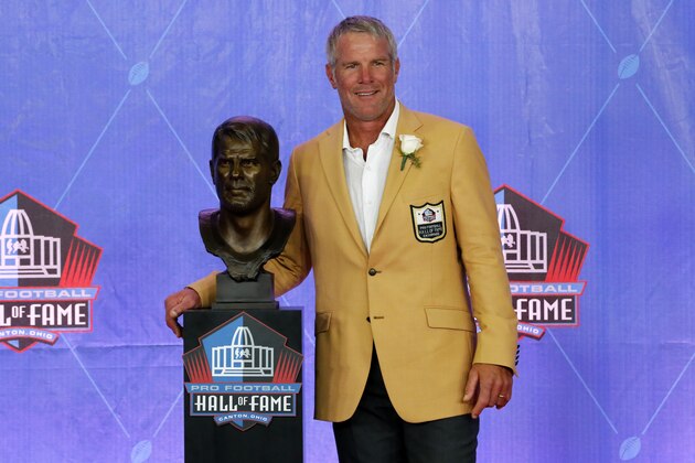 Former NFL player Brett Favre poses with a bust of himself during an induction ceremony at the Pro Football Hall of Fame, Saturday, Aug. 6, 2016, in Canton, Ohio. (AP Photo/Gene J. Puskar)