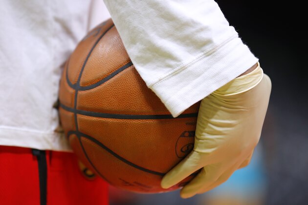 ATLANTA, GA - MARCH 09:  Ballboys wear gloves while handling warmup basketballs as a precautionary measure prior to an NBA game between the Charlotte Hornets and Atlanta Hawks at State Farm Arena on March 9, 2020 in Atlanta, Georgia. NOTE TO USER: User expressly acknowledges and agrees that, by downloading and/or using this photograph, user is consenting to the terms and conditions of the Getty Images License Agreement. (Photo by Todd Kirkland/Getty Images)