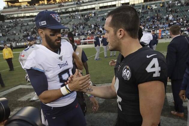Tennessee Titans quarterback Marcus Mariota, left, greets Oakland Raiders quarterback Derek Carr after an NFL football game in Oakland, Calif., Sunday, Dec. 8, 2019. (AP Photo/Ben Margot)
