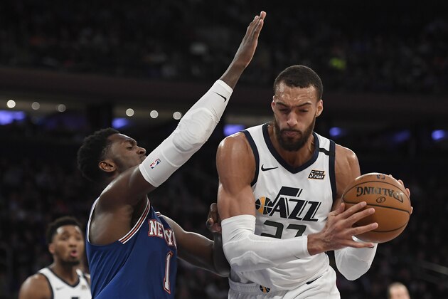 Utah Jazz center Rudy Gobert (27) dribbles the ball as New York Knicks forward Bobby Portis (1) defends during the second half of an NBA basketball game in New York, Wednesday, March 4, 2020. (AP Photo/Sarah Stier) Utah Jazz center Rudy Gobert (27) dribbles the ball as New York Knicks forward Bobby Portis (1) defends during the second half of an NBA basketball game in New York, Wednesday, March 4, 2020. (AP Photo/Sarah Stier)