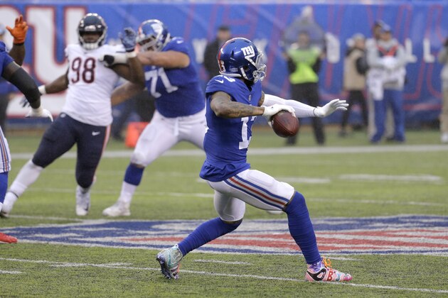 New York Giants wide receiver Odell Beckham prepares to launch a touchdown pass to wide receiver Russell Shepard, not pictured, during the second half of an NFL football game against the Chicago Bears, Sunday, Dec. 2, 2018, in East Rutherford, N.J. (AP Photo/Seth Wenig)