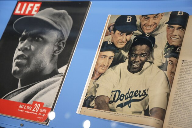 In this Tuesday, Jan. 29, 2019 photo, news articles about Brooklyn Dodgers baseball player Jackie Robinson are displayed at the exhibit