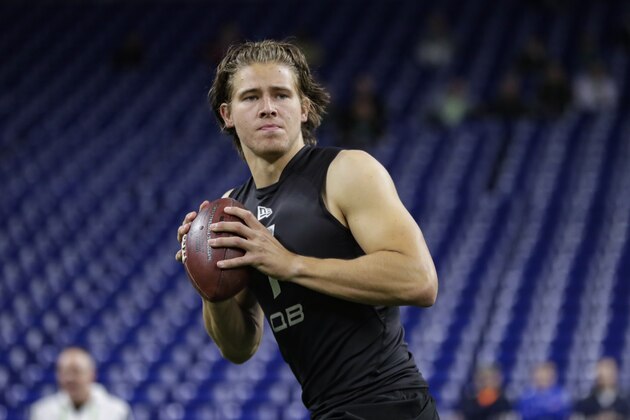 Oregon quarterback Justin Herbert runs a drill at the NFL football scouting combine in Indianapolis, Thursday, Feb. 27, 2020. (AP Photo/Michael Conroy)