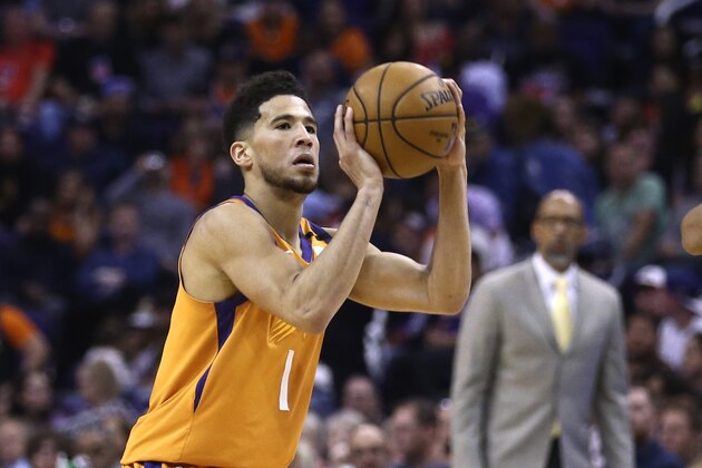 Phoenix Suns guard Devin Booker gets ready to shoot the ball against the Portland Trail Blazers during the second half of an NBA basketball game Friday, March 6, 2020, in Phoenix. The Suns defeated the Trail Blazers 127-117. (AP Photo/Ross D. Franklin)