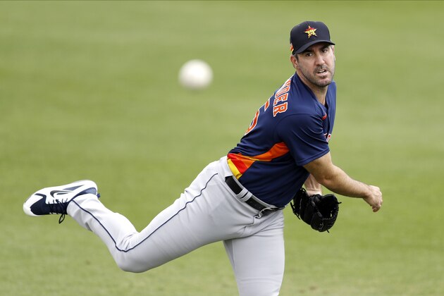 FILE - In this March 3, 2020, file photo, Houston Astros pitcher Justin Verlander warms up prior to the team's spring training baseball game against the St. Louis Cardinals in Jupiter, Fla.  Verlander has resumed throwing as he recovers from March groin surgery. Houston manager Dusty Baker said Wednesday, April 15, that Verlander, who had surgery on March 17, is â€œdoing great