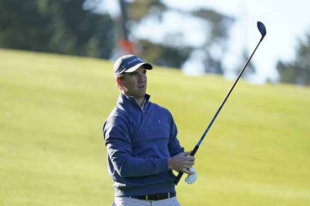 Eli Manning follows his shot from the first fairway of the Spyglass Hill Golf Course during the first round of the AT&T Pebble Beach National Pro-Am golf tournament Thursday, Feb. 6, 2020, in Pebble Beach, Calif. (AP Photo/Tony Avelar)