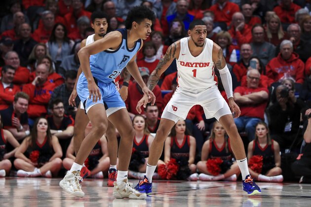 Rhode Island's Jacob Toppin, left, stands against Dayton's Obi Toppin in the first half of an NCAA college basketball game, Tuesday, Feb. 11, 2020, in Dayton, Ohio. Dayton won 81-67. (AP Photo/Aaron Doster)