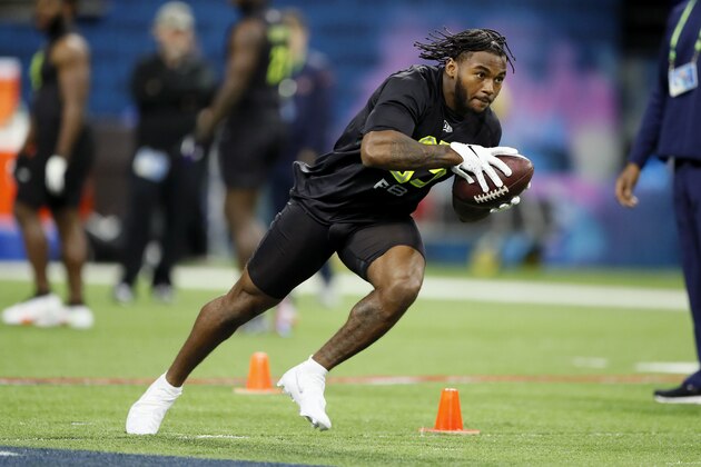 FILE - In this Feb. 28, 2020, file photo, Georgia running back D'Andre Swift runs a drill at the NFL football scouting combine in Indianapolis. The Chiefs also could benefit from the fact that few other teams need a running back, making elite talent such as Georgia's D’Andre Swift and Wisconsin's Jonathan Taylor could be there for the taking on Thursday night, April 23 at the NFL Draft. (AP Photo/Charlie Neibergall, File)