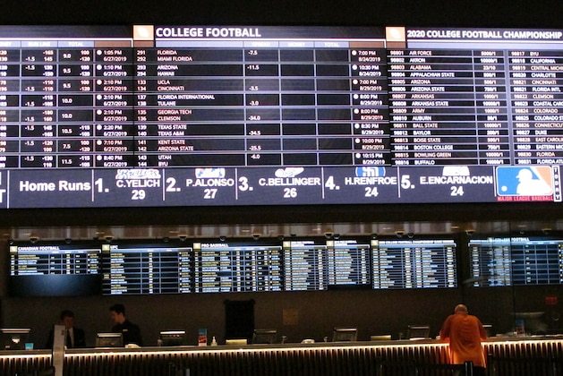 In this June 27, 2019 photo, a gambler places a bet at the new sportsbook at Bally's casino in Atlantic City, N.J. New Jersey surpassed Nevada in terms of sports betting volume in May, taking the national lead for the first time. (AP Photo/Wayne Parry) In this June 27, 2019 photo, a gambler places a bet at the new sportsbook at Bally's casino in Atlantic City, N.J. New Jersey surpassed Nevada in terms of sports betting volume in May, taking the national lead for the first time. (AP Photo/Wayne Parry)