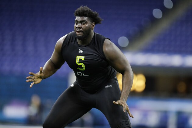 Louisville offensive lineman Mekhi Becton runs a drill at the NFL football scouting combine in Indianapolis, Friday, Feb. 28, 2020. (AP Photo/Michael Conroy)