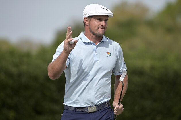 Bryson DeChambeau acknowledges the crowd after making a putt on the 14th green during the final round of the Arnold Palmer Invitational golf tournament, Sunday, March 8, 2020, in Orlando, Fla. (AP Photo/Phelan M. Ebenhack)