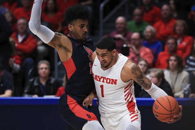 Dayton's Obi Toppin (1) drives to the basket against Duquesne's Michael Hughes (21) in the second half of an NCAA college basketball game, Saturday, Feb. 22, 2020, in Dayton, Ohio.Dayton won 80-70. (AP Photo/Aaron Doster)