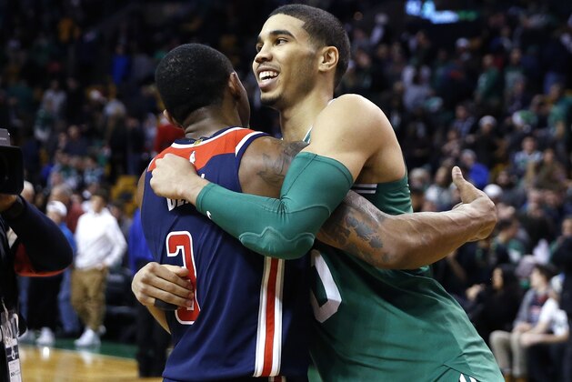 Boston Celtics' Jayson Tatum (0) hugs Washington Wizards' Bradley Beal (3) following an NBA basketball game in Boston, Monday, Dec. 25, 2017. The Wizards won 111-103. (AP Photo/Michael Dwyer)