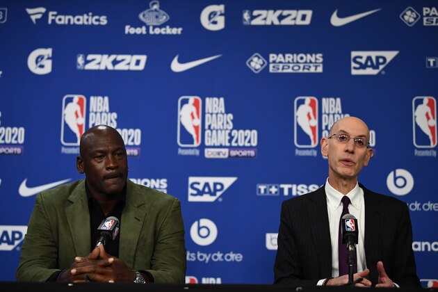 Former NBA star and owner of Charlotte Hornets team Michael Jordan (L) looks on as NBA commissioner Adam Silver addresses a press conference ahead of the NBA basketball match between Milwaukee Bucks and Charlotte Hornets at The AccorHotels Arena in Paris on January 24, 2020. (Photo by FRANCK FIFE / AFP) (Photo by FRANCK FIFE/AFP via Getty Images)