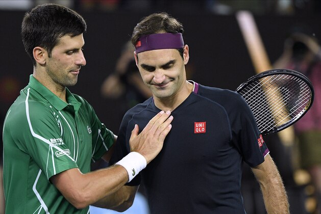 Switzerland's Roger Federer, right, congratulates Serbia's Novak Djokovic on winning their semifinal match at the Australian Open tennis championship in Melbourne, Australia, Thursday, Jan. 30, 2020. (AP Photo/Andy Brownbill)