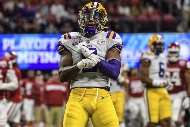 LSU linebacker Patrick Queen (8) celebrates during the Peach Bowl NCAA semifinal college football playoff game against Oklahoma, Saturday, Dec. 28, 2019, in Atlanta. (AP Photo/Danny Karnik)
