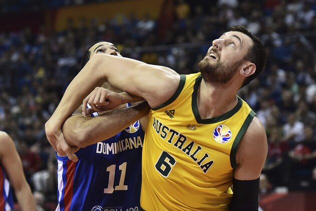 Andrew Bogut of Australia battles for a rebound with Eloy Vargas of the Dominican Republic during their second round basketball game in the FIBA Basketball World Cup in Nanjing in eastern China's Jiangsu province, Saturday, Sept. 7, 2019. (AP Photo)