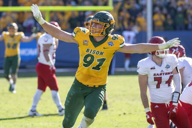 North Dakota State defensive end Derrek Tuszka (91) waves his arms like an eagle, Eastern Washington's mascot, after sacking Eastern Washington quarterback Eric Barriere in the final minutes of the FCS championship NCAA college football game, Saturday, Jan. 5, 2019, in Frisco, Texas. North Dakota State won 38-24. (AP Photo/Jeffrey McWhorter)