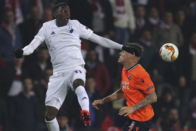 Basaksehir's Martin Skrtel right, fights for the ball with Copenhagen's Mohamed Daramy, left, during a Europa League top 16 first leg soccer match between Basaksehir and Copenhagen, in Istanbul, Thursday, March 12, 2020. (AP Photo)