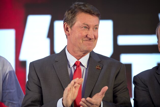 Former NHL hockey player Wayne Gretzky applauds during a promotional event for the Beijing Kunlun Red Star hockey team in his role as global ambassador for the team, part of the Russia-based Kontinental Hockey League, in Beijing, Thursday, Sept. 13, 2018. Gretzky says the NHL should again allow its players to compete in the Winter Olympics because sending the world's top hockey players is
