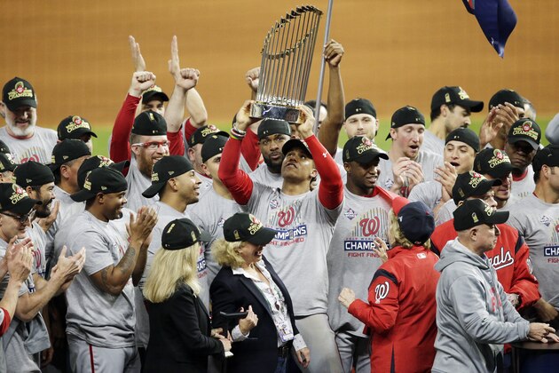 HOUSTON, TEXAS - OCTOBER 30:  Juan Soto #22 of the Washington Nationals hoists the Commissioners Trophy after defeating the Houston Astros 6-2 in Game Seven to win the 2019 World Series in Game Seven of the 2019 World Series at Minute Maid Park on October 30, 2019 in Houston, Texas. (Photo by Bob Levey/Getty Images)