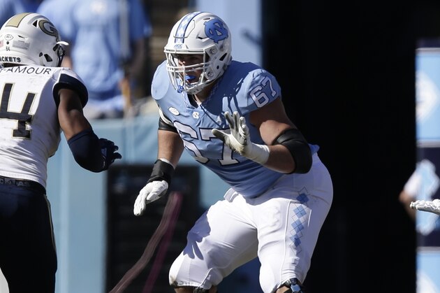 North Carolina's Charlie Heck (67) blocks Georgia Tech's Anree Saint-Amour (94) during the first half of an NCAA college football game in Chapel Hill, N.C., Saturday, Nov. 3, 2018. (AP Photo/Gerry Broome) North Carolina's Charlie Heck (67) blocks Georgia Tech's Anree Saint-Amour (94) during the first half of an NCAA college football game in Chapel Hill, N.C., Saturday, Nov. 3, 2018. (AP Photo/Gerry Broome)