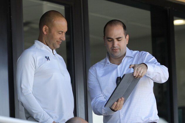 Miami Marlins CRO Adam Jones, right, shows a tablet to Marlins CEO Derek Jeter during the eighth inning of a spring training baseball game between the Washington Nationals and the Marlins, Tuesday, March 10, 2020, in Jupiter, Fla. (AP Photo/Julio Cortez) Miami Marlins CRO Adam Jones, right, shows a tablet to Marlins CEO Derek Jeter during the eighth inning of a spring training baseball game between the Washington Nationals and the Marlins, Tuesday, March 10, 2020, in Jupiter, Fla. (AP Photo/Julio Cortez)