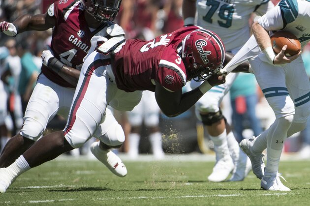 Coastal Carolina quarterback Kilton Anderson (7) attempts to escape South Carolina defensive lineman Javon Kinlaw (3) during the first half of an NCAA college football game Saturday, Sept. 1, 2018, in Columbia, S.C. (AP Photo/Sean Rayford)
