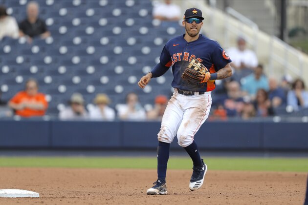 Houston Astros shortstop Carlos Correa waits for the toss from second baseman Alex De Goti before turning a double play against the Detroit Tigers during the sixth inning of a spring training baseball game, Monday, March 9, 2020, in West Palm Beach, Fla. (AP Photo/Julio Cortez)