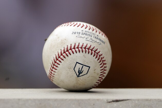 A spring training baseball ball with a Cactus League logo sits on a dugout wall during a game between the Arizona Diamondbacks and Los Angeles Angels Thursday, March 21, 2019, in Scottsdale, Ariz. (AP Photo/Elaine Thompson)