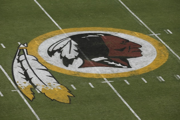 The Washington Redskins logo is seen on the field before an NFL football preseason game against the New England Patriots in Landover, Md., Thursday, Aug. 7, 2014. (AP Photo/Alex Brandon)