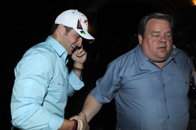 Denver Broncos first-round draft pick Tim Tebow, left, talks on his cell-phone while arriving for an after-draft news conference with his agent Jimmy Sexton at the Glen Kernan Golf & Country Club Jacksonville, Fla., Thursday, April 22, 2010.  Tebow was selected with the 25th pick of the NFL football draft. (AP Photo/Phelan M. Ebenhack)