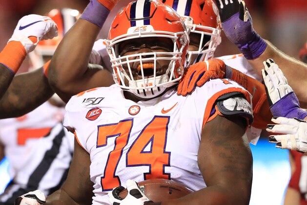 RALEIGH, NORTH CAROLINA - NOVEMBER 09: John Simpson #74 of the Clemson Tigers reacts after running for a touchdown against the North Carolina State Wolfpack during their game at Carter-Finley Stadium on November 09, 2019 in Raleigh, North Carolina. (Photo by Streeter Lecka/Getty Images)