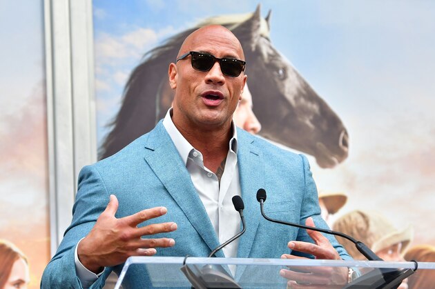 Actor Dwayne Johnson speaks at Kevin Hart's Hand and Footprints ceremony in Hollywood, California on December 10, 2019. (Photo by Frederic J. BROWN / AFP) (Photo by FREDERIC J. BROWN/AFP via Getty Images)