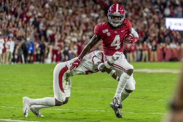 Alabama wide receiver Jerry Jeudy (4) eludes Arkansas defensive back Montaric Brown (21) to break free for a touchdown reception during the first half of an NCAA college football game, Saturday, Oct. 26, 2019, in Tuscaloosa, Ala. (AP Photo/Vasha Hunt)