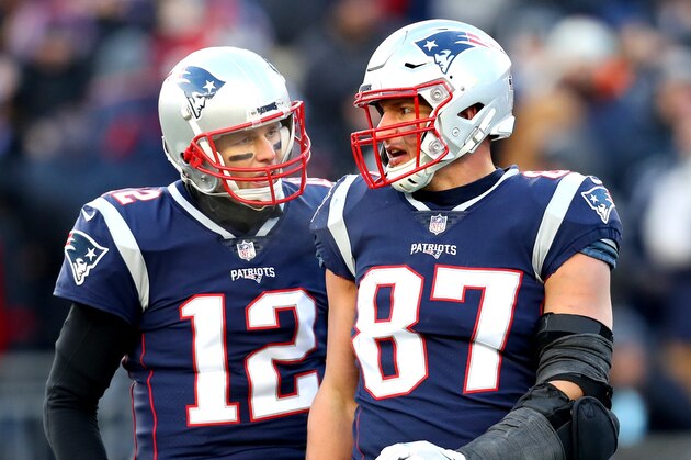 FOXBOROUGH, MASSACHUSETTS - JANUARY 13: Tom Brady #12 of the New England Patriots reacts with Rob Gronkowski #87 during the third quarter in the AFC Divisional Playoff Game against the Los Angeles Chargers at Gillette Stadium on January 13, 2019 in Foxborough, Massachusetts. (Photo by Maddie Meyer/Getty Images)