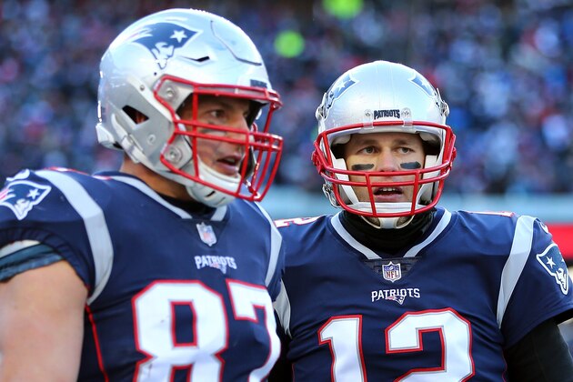 FOXBOROUGH, MASSACHUSETTS - JANUARY 13: Tom Brady #12 of the New England Patriots and Rob Gronkowski #87 react during the second quarter in the AFC Divisional Playoff Game against the Los Angeles Chargers at Gillette Stadium on January 13, 2019 in Foxborough, Massachusetts. (Photo by Adam Glanzman/Getty Images)