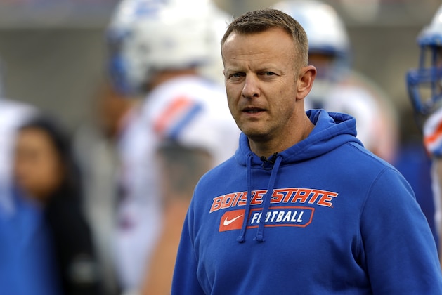 Boise State coach Bryan Harsin watches his players warm up for the Las Vegas Bowl NCAA college football game against Washington at Sam Boyd Stadium, Saturday, Dec. 21, 2019, in Las Vegas. (AP Photo/Steve Marcus)