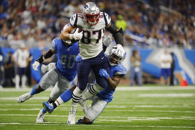 New England Patriots tight end Rob Gronkowski (87) tries pulling away from Detroit Lions defensive back Glover Quin (27) during the second half of an NFL football game, Sunday, Sept. 23, 2018, in Detroit. (AP Photo/Rick Osentoski)
