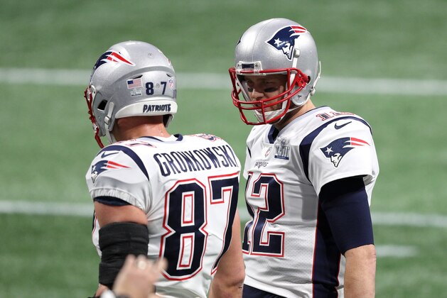 ATLANTA, GEORGIA - FEBRUARY 03:  Rob Gronkowski #87 and Tom Brady #12 of the New England Patriots speak to each other prior to Super Bowl LIII at Mercedes-Benz Stadium on February 03, 2019 in Atlanta, Georgia. (Photo by Patrick Smith/Getty Images)