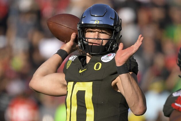 FILE - In this Jan. 1, 2020, file photo, Oregon quarterback Justin Herbert passes against Wisconsin during first half of the Rose Bowl NCAA college football game in Pasadena, Calif. Herbert is a likely first-round pick in the NFL draft Thursday, April 23, 2020. (AP Photo/Mark J. Terrill, File)