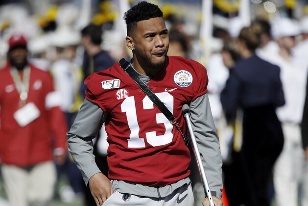 ORLANDO, FL - JANUARY 01: Injured quarterback Tua Tagovailoa #13 of the Alabama Crimson Tide leaves the field following warmups prior to the Vrbo Citrus Bowl against the Michigan Wolverines at Camping World Stadium on January 1, 2020 in Orlando, Florida. Alabama defeated Michigan 35-16. (Photo by Joe Robbins/Getty Images)