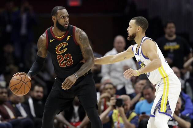 Cleveland Cavaliers' LeBron James is defended by Golden State Warriors' Stephen Curry during the first half of Game 4 of basketball's NBA Finals, Friday, June 8, 2018, in Cleveland. (AP Photo/Tony Dejak)
