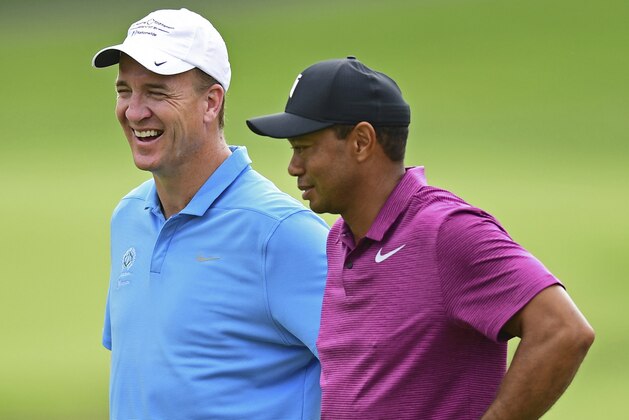 Peyton Manning, left, laughs while talking with Tiger Woods on the eleventh hole during the pro-am for the the Memorial golf tournament Wednesday, May 30, 2018, in Dublin, Ohio. (AP Photo/David Dermer)