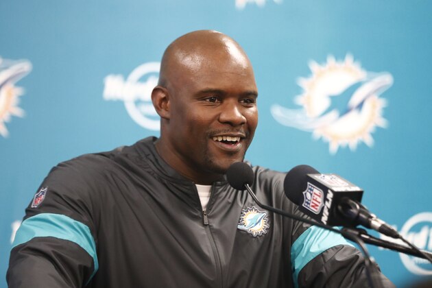 Miami Dolphins head coach Brian Flores smiles during a post- game news conference following an NFL football game against the Cincinnati Bengals, Sunday, Dec. 22, 2019, in Miami Gardens, Fla. The Dolphins defeated the Bengals 38-35 in overtime. (AP Photo/Brynn Anderson)