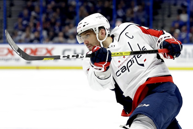 FILE - In this Dec. 14, 2019, file photo, Washington Capitals left wing Alex Ovechkin follows through on a shot against the Tampa Bay Lightning during the first period of an NHL hockey game in Tampa, Fla. Possibly losing as many as 13 games with the NHL on hold because of the coronavirus pandemic could leave Ovechkin two short of another 50-goal season and threaten his ability to break Wayne Gretzkyâ€™s all-time record. (AP Photo/Chris O'Meara, File)