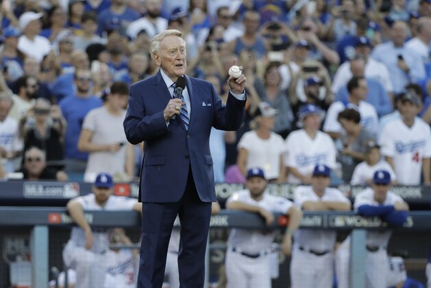 Vin Scully helps throw out the ceremonial first pitch before Game 2 of baseball's World Series between the Houston Astros and the Los Angeles Dodgers Wednesday, Oct. 25, 2017, in Los Angeles. (AP Photo/David J. Phillip)