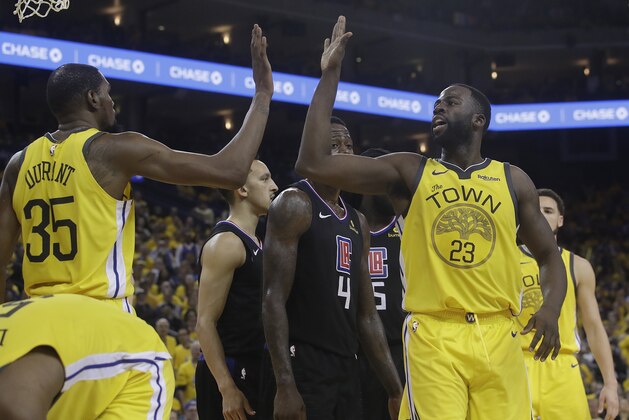 Golden State Warriors forward Kevin Durant (35) celebrates with forward Draymond Green (23) during the second half of Game 2 of a first-round NBA basketball playoff series against the Los Angeles Clippers in Oakland, Calif., Monday, April 15, 2019. (AP Photo/Jeff Chiu)