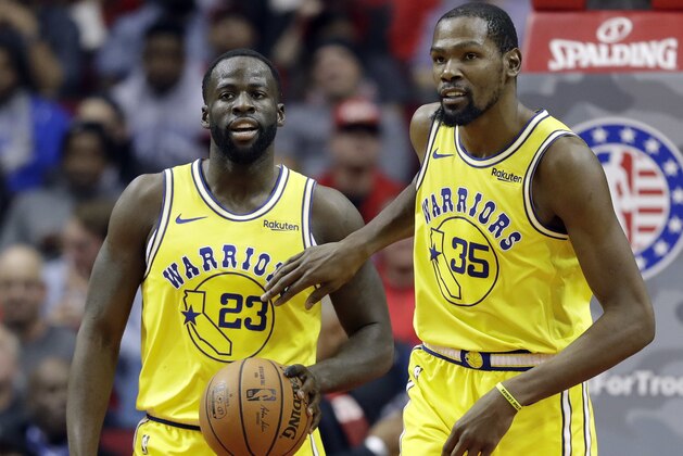 Golden State Warriors' Kevin Durant (35) pats Draymond Green (23) on the chest after a turnover during the second half of an NBA basketball game against the Houston Rockets Thursday, Nov. 15, 2018, in Houston. (AP Photo/David J. Phillip)